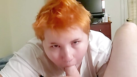 Hot redhead with tattooed body is eating and licking